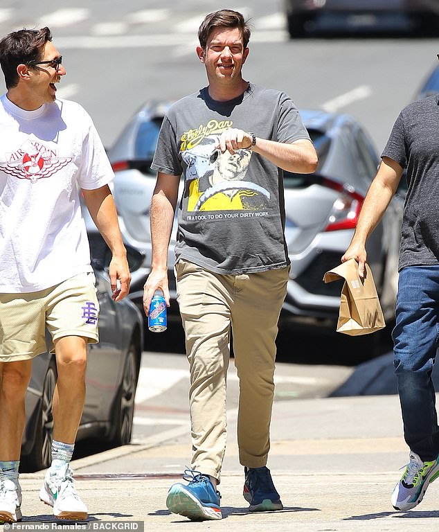 Taking it easy: Mulaney later switched into a t-shirt that featured a graphic print of Steely Dan's logo during his time with his friends in the Big Apple