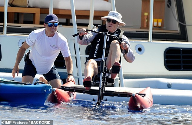 Active: Robert then worked up a sweat by climbing on board a water bike and peddling round the water