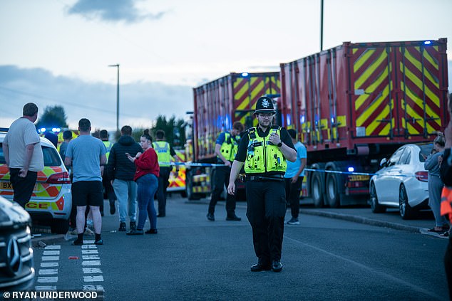 Large crowds have gathered around the cordon after news of the blast on Dulwich Road, Kingstanding, Birmingham, spread