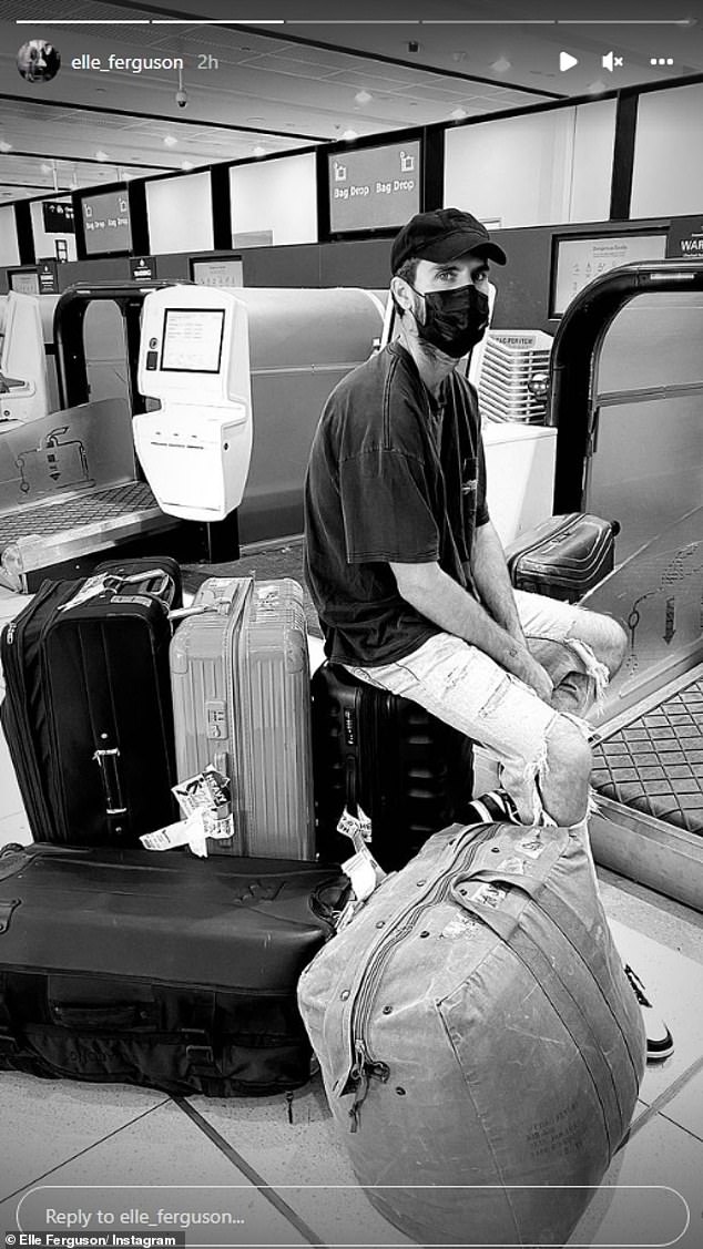 Telling sign: She also shared a black-and-white image of her partner Joel sitting with their luggage as they prepared to catch a flight to Adelaide