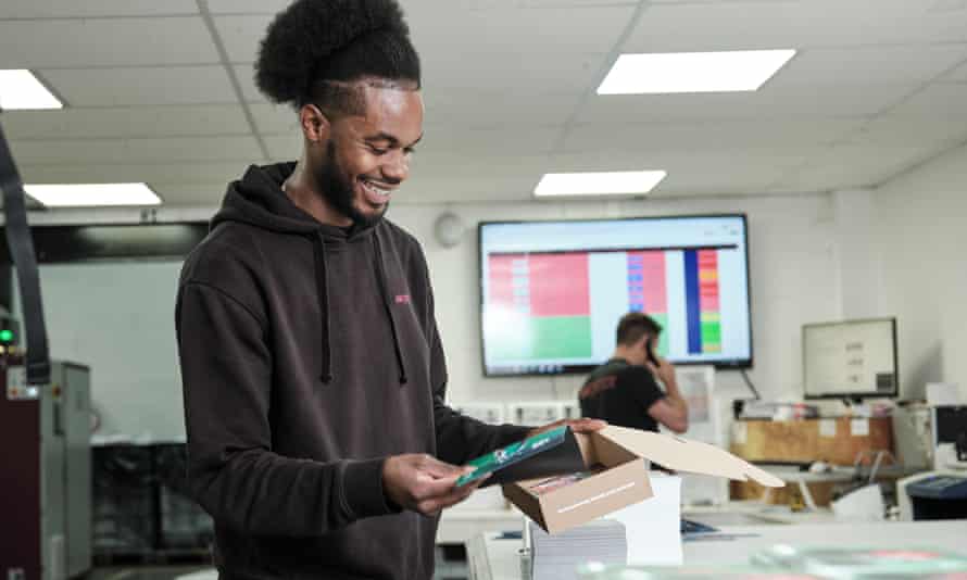 A worker inspects printed products