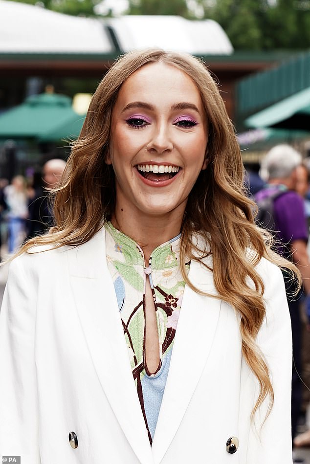 Beautiful: Her glossy tresses were styled in neat waves that cascaded over her shoulders and she opted for bright pink eyeshadow