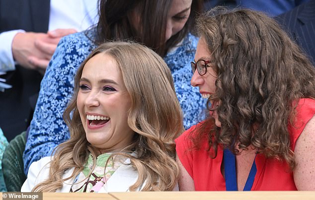 Giggles: The Strictly Come Dancing champion shared a laugh with a friend as she sat in the stands