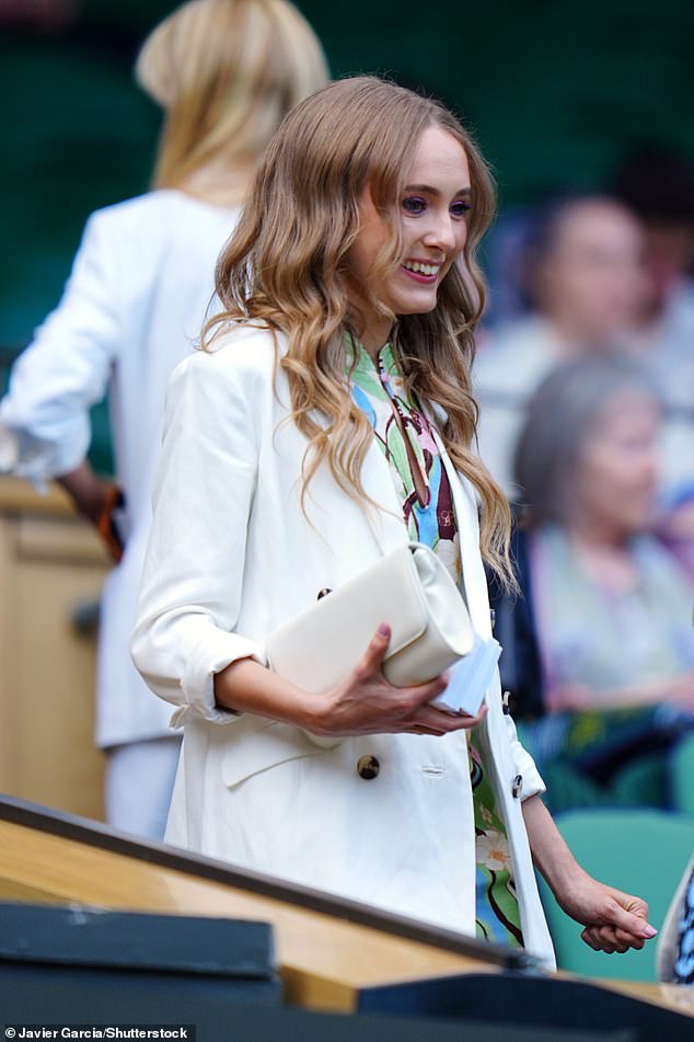 Fashion forward: She wore a pair of beige high heels, and carried her essentials in a white clutch handbag