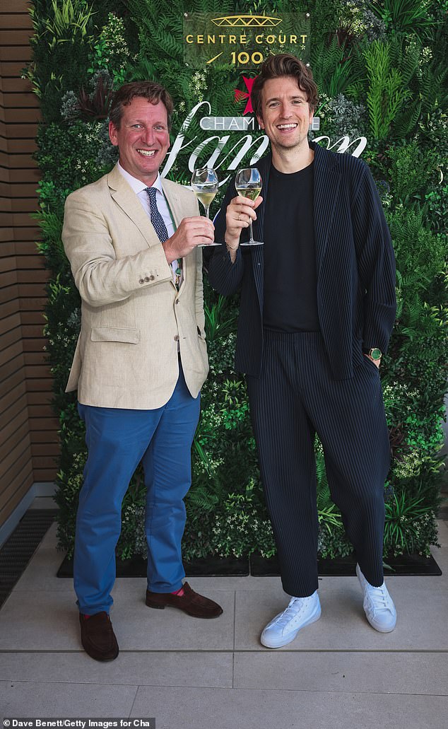 Debonair: He posed alongside Robert Rand, who looked debonair in a beige jacket, with a white shirt with blue trousers and a coordinating tie