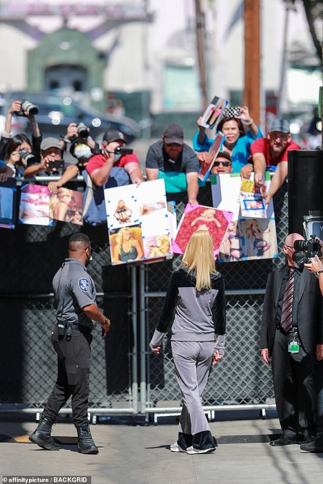 Safety first: Paris was surrounded by several security guards as she spent time with her diehard fans