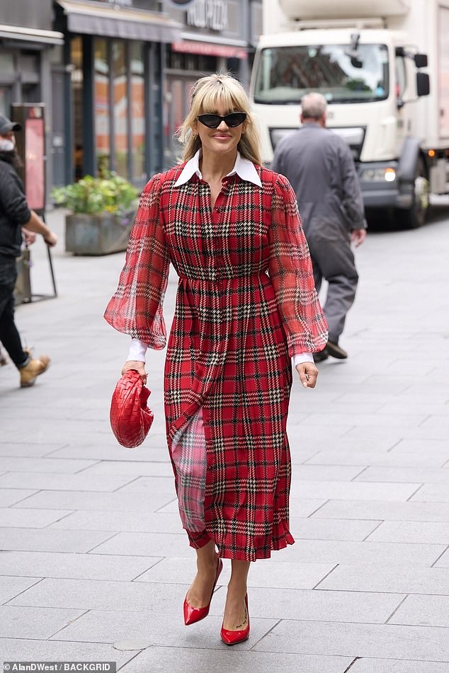 Lady in red: She elevated her height with a pair of red pointed heels and toted her essentials in a small red handbag