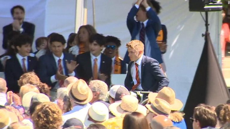 Paralyzed hockey player walks across stage to accept diploma