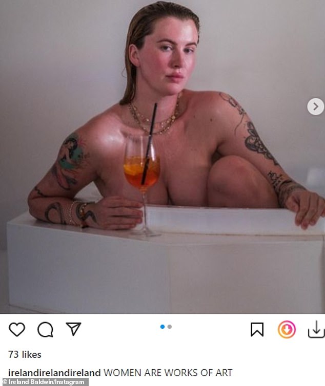 Alec Baldwin’s daughter Ireland, 26, shows off her tattoos as she poses NUDE in bathtub