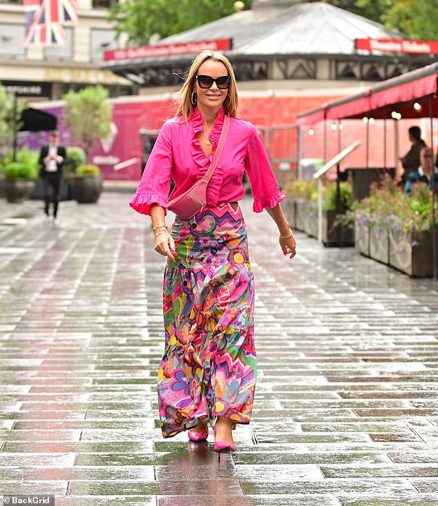 Amanda Holden brings some summer style to her stroll from work in a frilly pink shirt