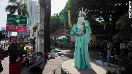 Theary Seng stands outside the Phnom Penh Municipal Court on Tuesday.