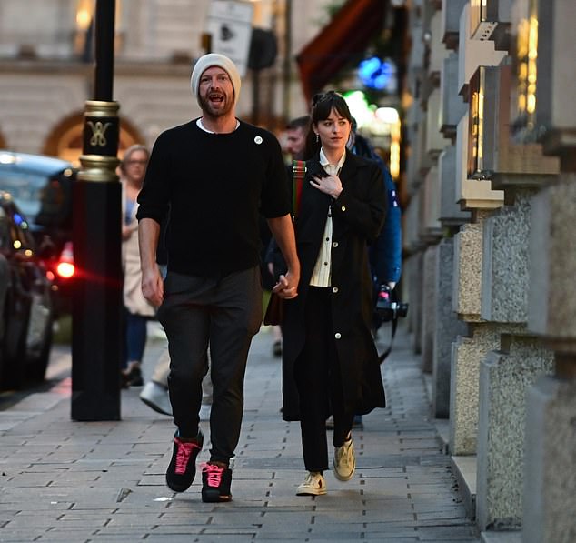 Chris Martin and Dakota Johnson look every inch the loved-up couple as they hold hands on date night