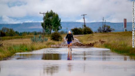 Sandes fording a river during the 16-day run around Lesotho. He says he went through a pair of socks every day.