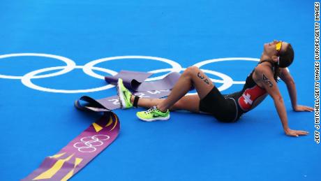 An exhausted Spirig lies on the ground at the end of the London 2012 Olympics. 