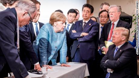 German Chancellor Angela Merkel deliberates with US President Donald Trump on the sidelines of the G7 summit in Charlevoix, Canada, 2018.  