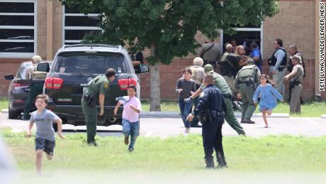 Students run to safety after escaping from a window at Robb Elementary School on Tuesday, May 24.