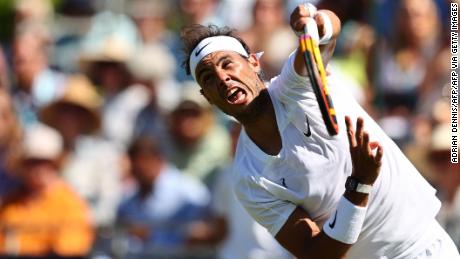 Nadal hits a serve during an exhibition match against Stan Wawrinka at the Hurlingham Club in London.