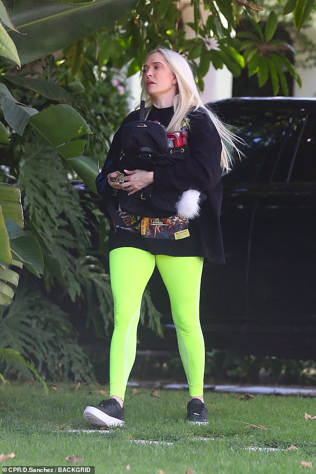 Turning 51 on July 10! The Pretty Mess Hair founder sported neon-green leggings with a black pulp fiction-inspired sweatshirt emblazoned with phrases like 'captive wild woman' and 'voodoo woman'