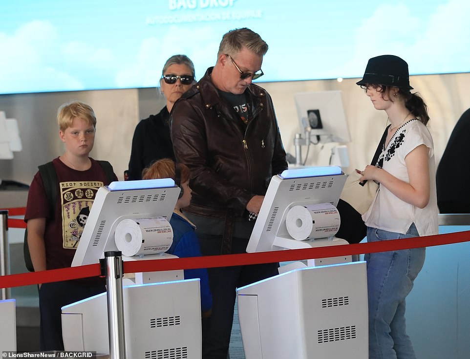 Homme, 49, is seen checking in while a boy believed to be Orrin looks on behind. Camille is thought to be the girl standing next to her father. Her restraining order against him was granted in September, and rescinded in April