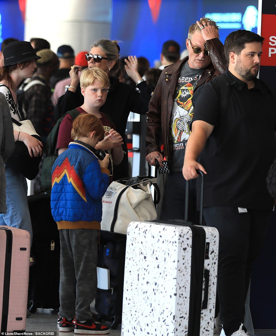 Homme, his two sons and his daughter all lined up to board their Delta flight