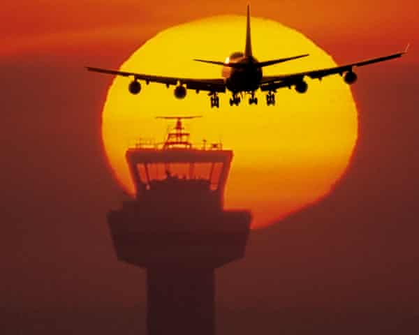 A plane in the sky over an airport