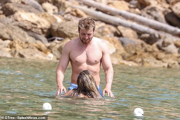 Cosy display: Zara and Sam looked adorable as they splashed around in the sea together to cool off