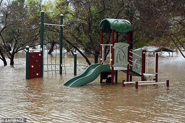 A children's playground half underwater as heavy rain battered the state