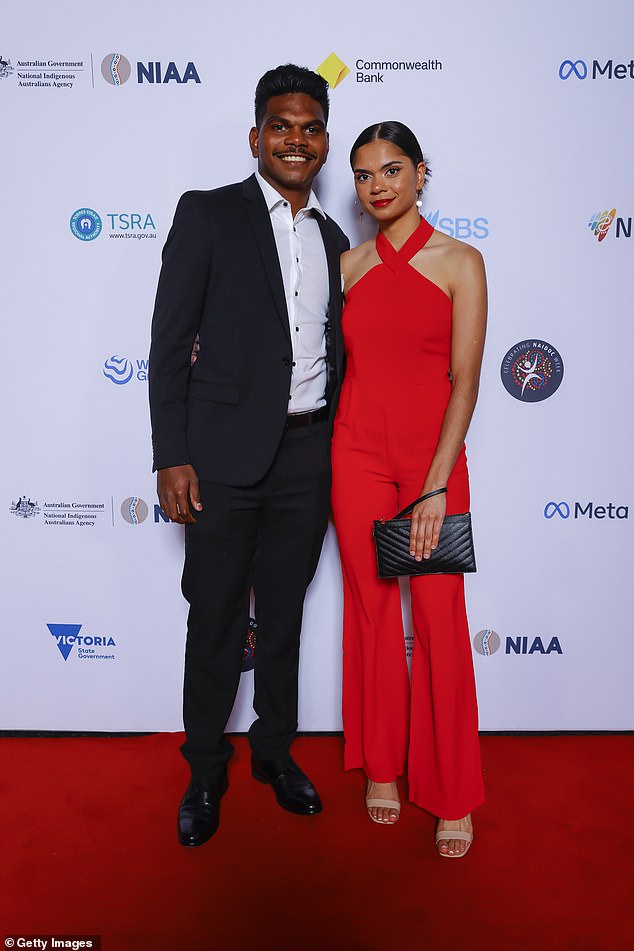 Footballer Maurice Rioli Jr went along with his gorgeous partner Madena Jaffer, who turned heads in a fire engine red jumpsuit, while he was chic in a black suit. Both pictured