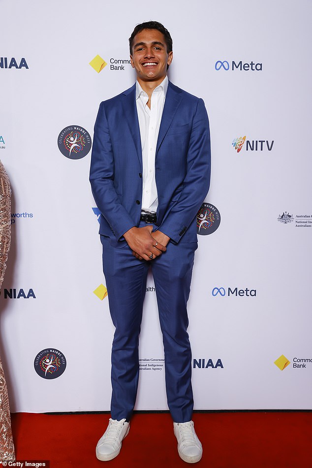 Footy player Jamarra Ugle-Hagan (pictured) chose a modern twist with a blue suit paired with a white dress shirt worn slightly unbuttoned