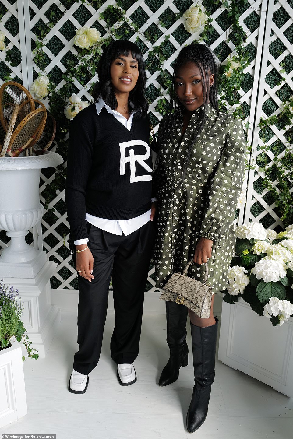 Looking good: Sabrina showcased her sensational style in a black jumper which she donned over a white shirt and trousers, teamed with chunky shoes while posing beside Isan Elba