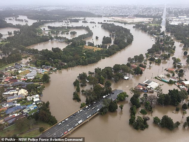 A combination of heavy rainfall and rapid dam spillages is causing rivers to rise at an alarming rate, shattering previous records (pictured, flooding in the Chipping Norton, Nepean and Hawkesbury areas)