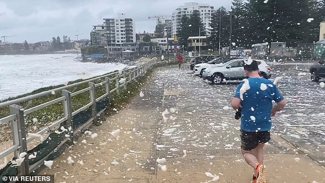 Sea foam is seen being blown around the car park near North Cronulla Beach on Sunday