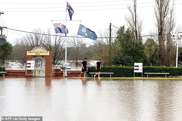 The Nepean River at Camden Weir peaked at 12.72m at about 2pm on Sunday and is currently at 12.68m and falling, with moderate flooding (pictured, Camden residents)