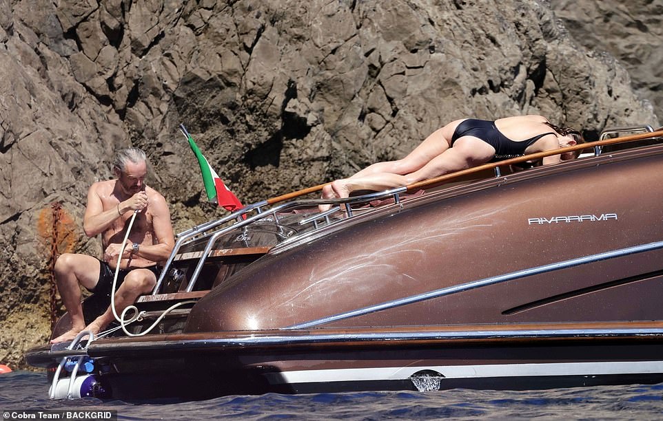 Relaxed: Stella lay across the top of the boat in the sun