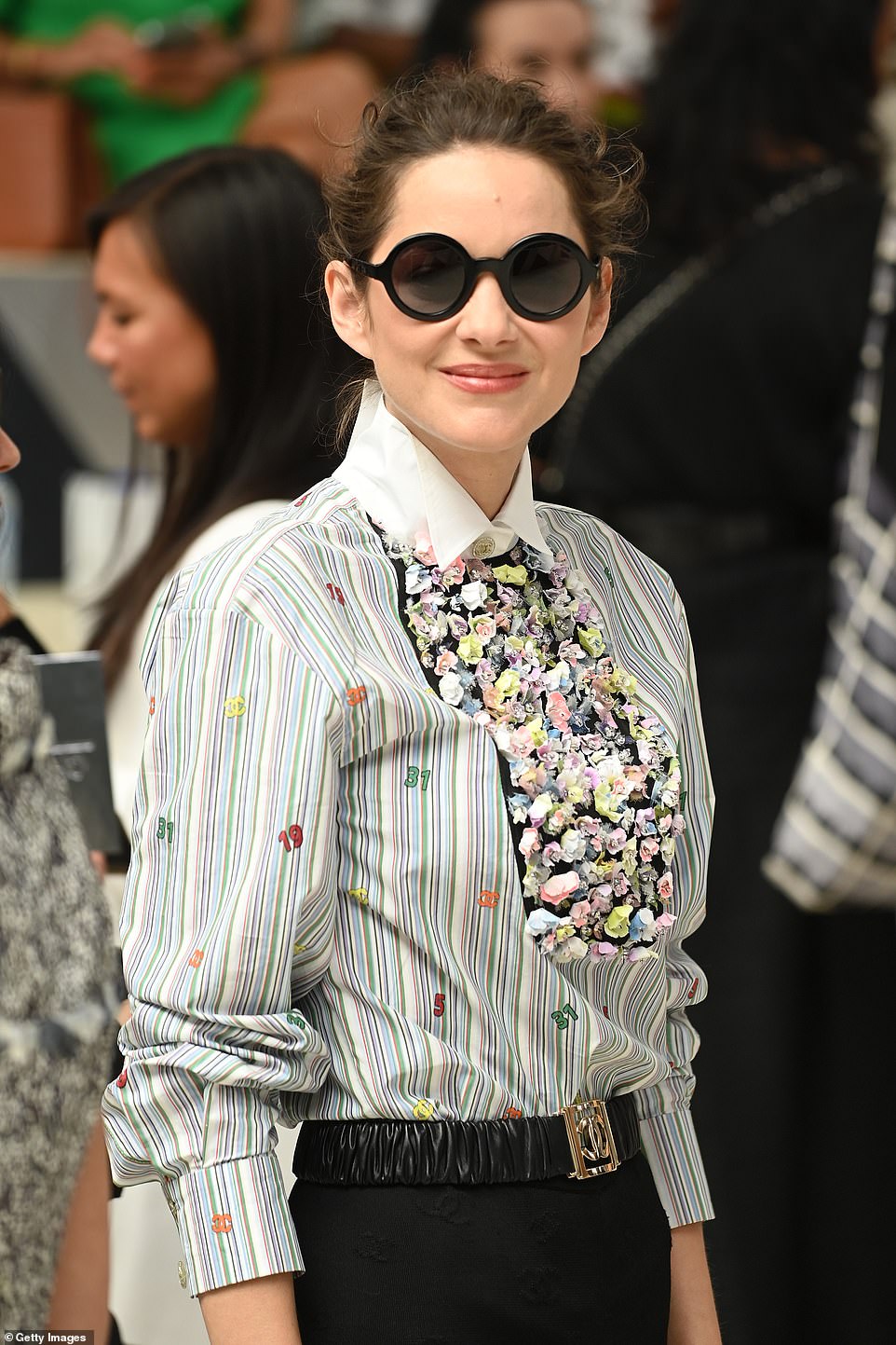 Turning heads: The French actress injected a splash of colour in a vibrant printed blouse and slung a boxy denim handbag over her shoulder