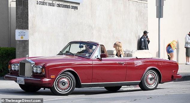 On the move: Letting her wavy hair down, she went for a naturalistic look where makeup was concerned and warded off the California rays with dark sunglasses