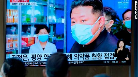 People in Seoul, South Korea, watch a TV news report about North Korean leader Kim Jong Un and his country&#39;s Covid outbreak in May.