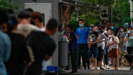 People stand in line at a coronavirus testing site in Beijing on July 4.