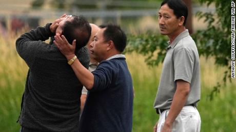 A man is overcome with emotion while search teams look for the bodies of a mother and her three children at Vadnais Lake on Saturday.