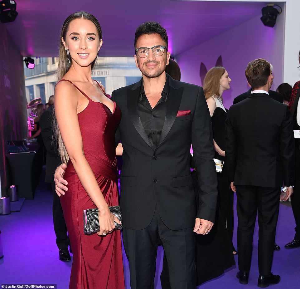 Glamorous: Peter, who himself sported a smart all-black suit, was seen grabbing a family snap or two with his two eldest kids, who he shares with ex-wife Katie Price