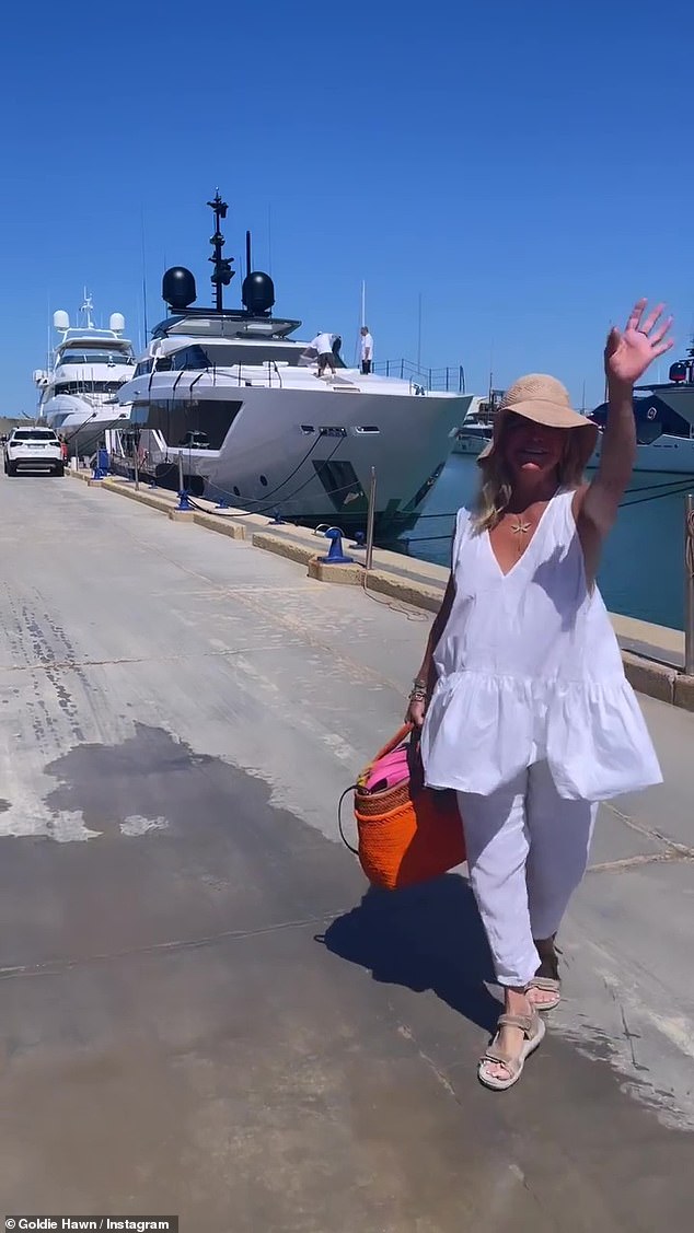 Flowing: She donned a flowing white sleeveless shirt and a pair of matching boating pants.