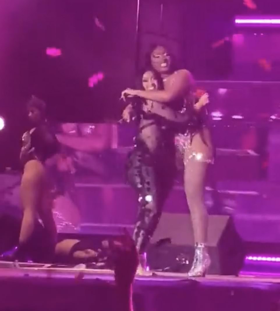 Close: Following the risqué performance, the two women gave each other a hug - beaming as they appeared happy with their high-energy display