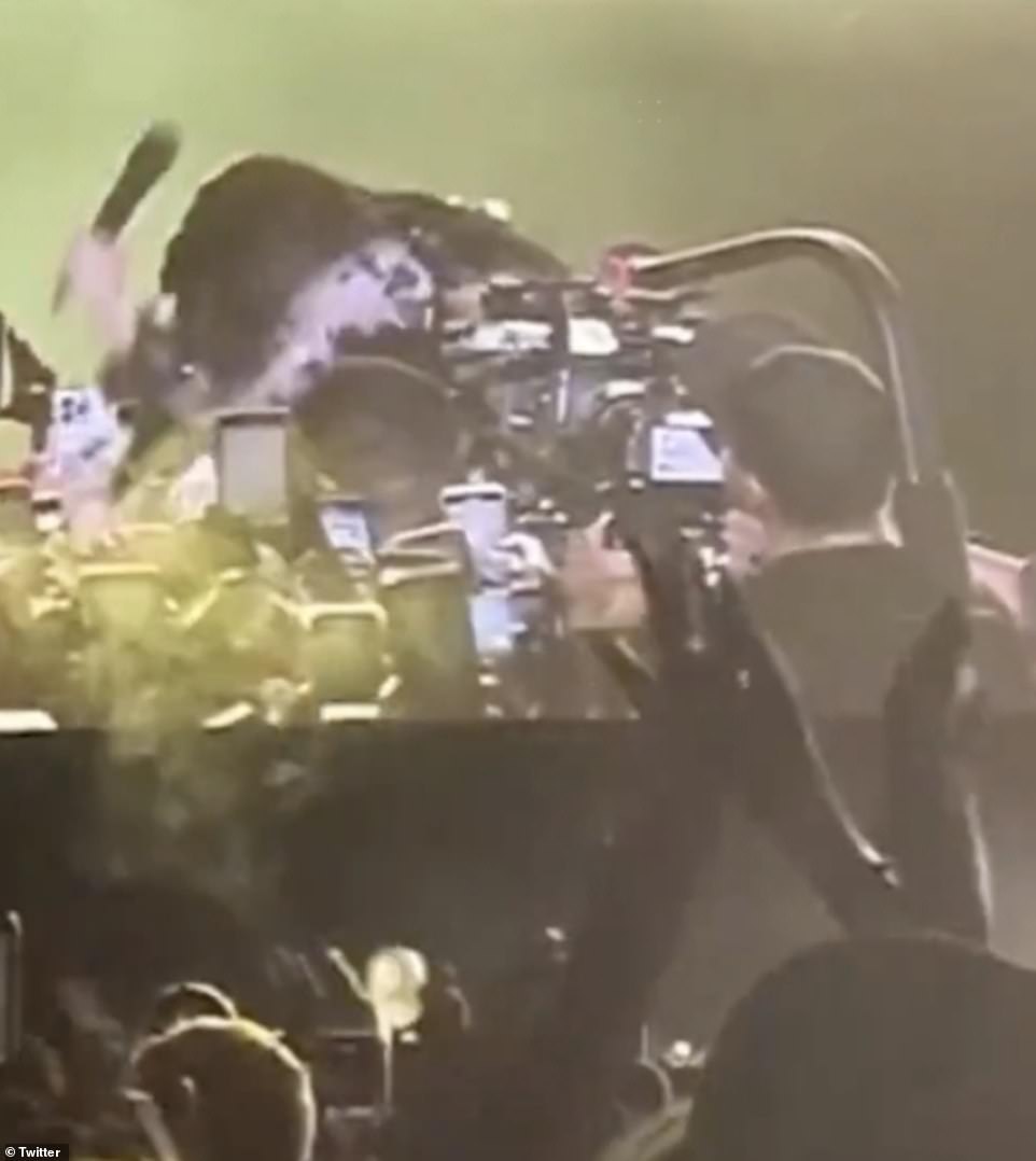 Heated? In a video posted by a fan in the crowd at the festival, Cardi bent over to the front of the crowd, before swinging her microphone in the air and seemingly hitting down