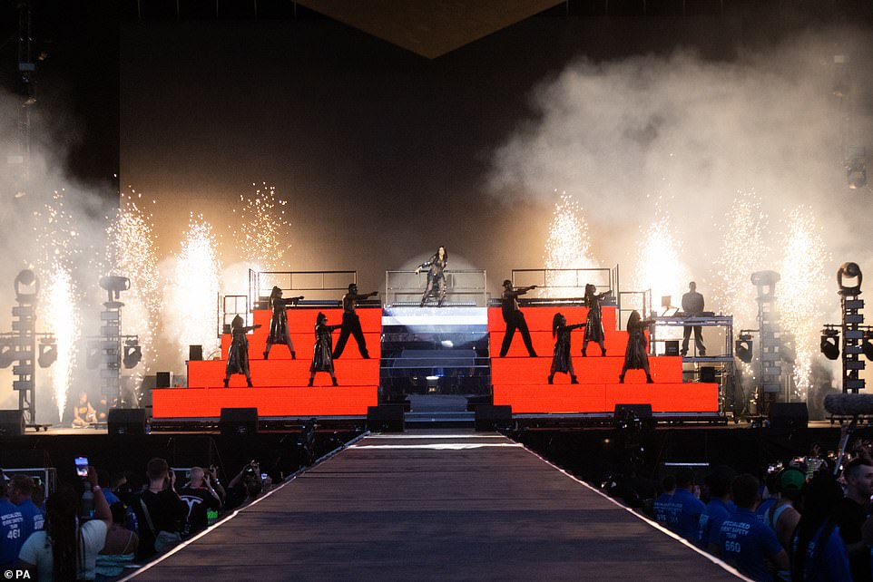 Fireworks: The songstress made her grand entrance down white steps as she was guided by two of her back up dancers