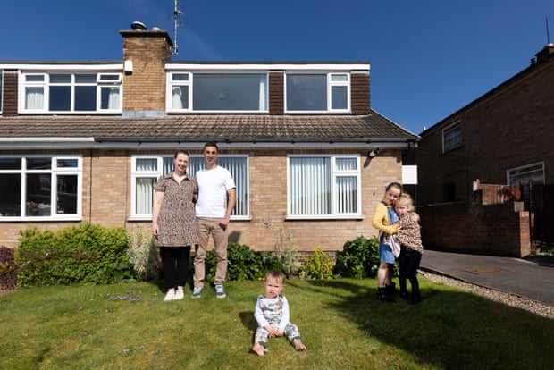 Alysia and Liam Cape and their children in the garden of the house they bought in Shepshed, Leicestershire, for £206,000