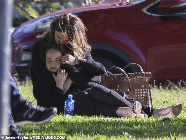 Little Aleeia matched her mum's outfit with a black jumper, tights and knee-high boots