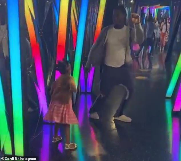 Enjoying themselves: The Migos member was later seen dancing with his daughter in a brightly-lit tunnel