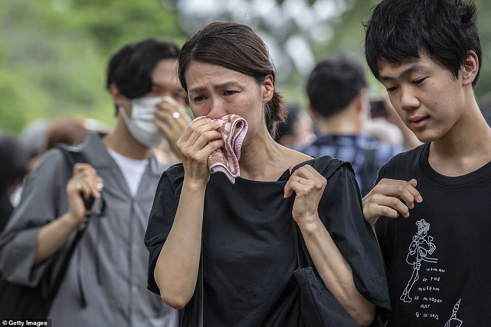 People weep and bow their heads in respect as the funeral for Shinzo Abe takes place in Tokyo today, following his assassination last week while at a campaign rally