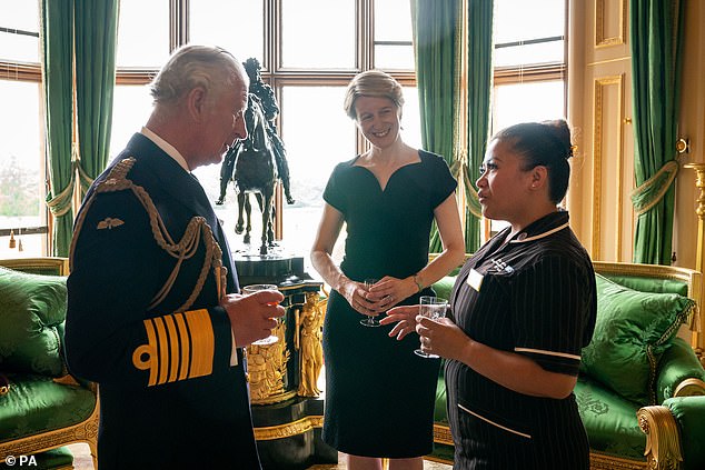 Sharing a glass with Prince Charles to toast the NHS, the George Cross celebrates the health service's efforts in rolling out the vaccine during the pandemic