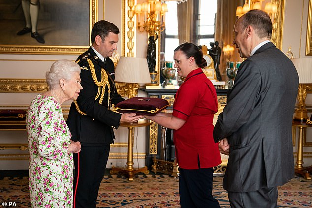 The 96-year-old was seen chatting with her visitors about the UK's healthcare service as she presented the honour